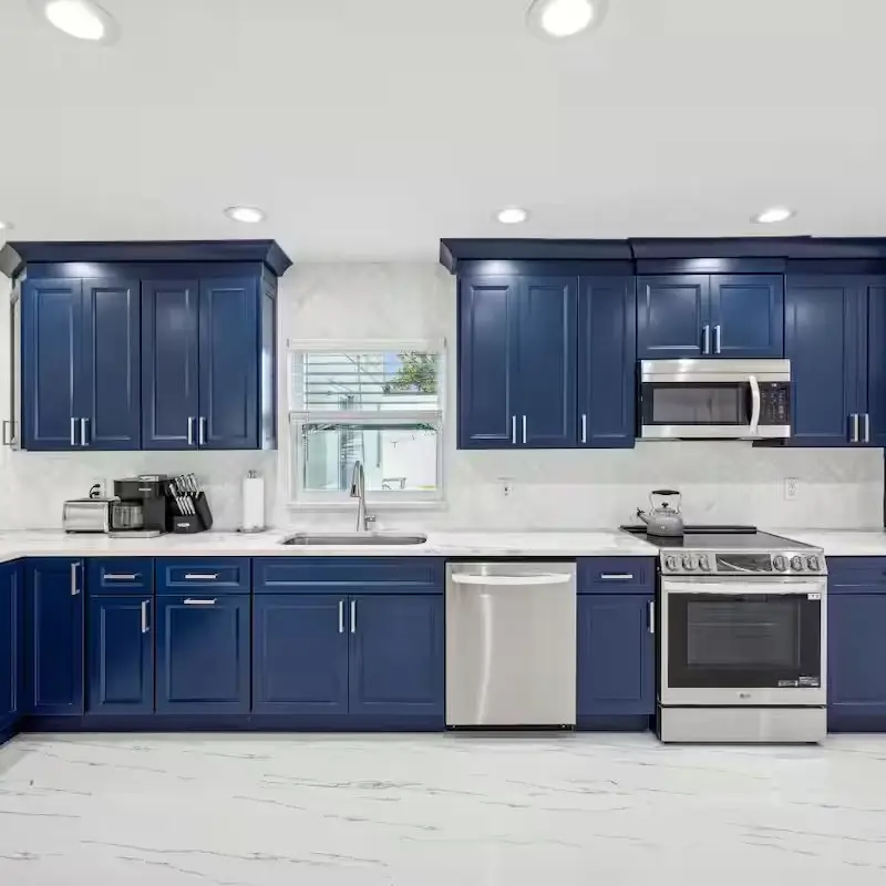 Kitchen remodel with navy blue cabinets and white countertops